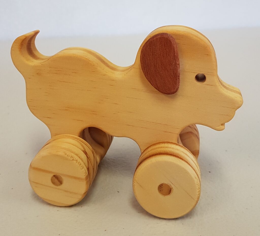 Wooden dog on wheels