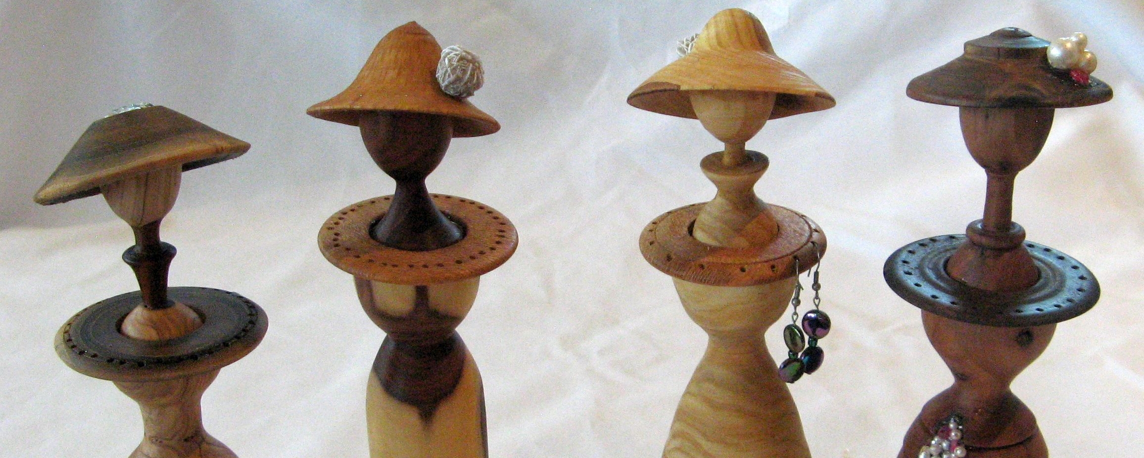 4 turned wooden earring stands
